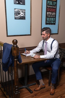 Man in suit sitting at table